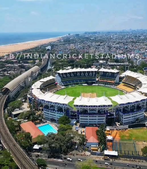 User-supplied aerial reference of Chepauk showing white canopy roofs, blue and yellow stands, and the pavilion